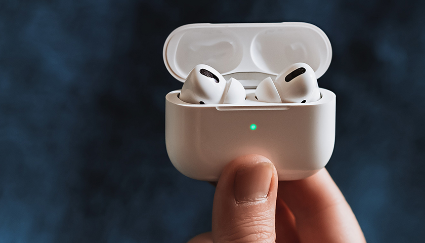 Person holding latest Apple Airpods