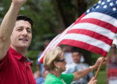 Paul Ryan wearing a red shirt and waving