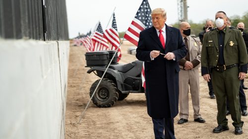 President Donald J. Trump prepares to sign a plaque placed along the border wall Tuesday, Jan. 12, 2021, at the Texas-Mexico border near Alamo, Texas.