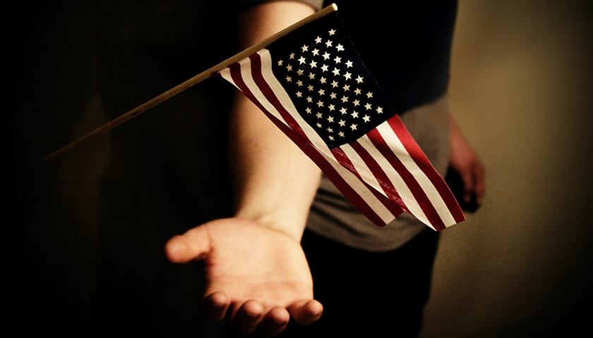 Hand underneath American flag