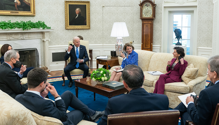 Joe Biden and his administration sitting in the Oval Office at the White House