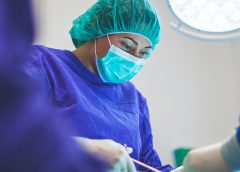 Woman performing surgery