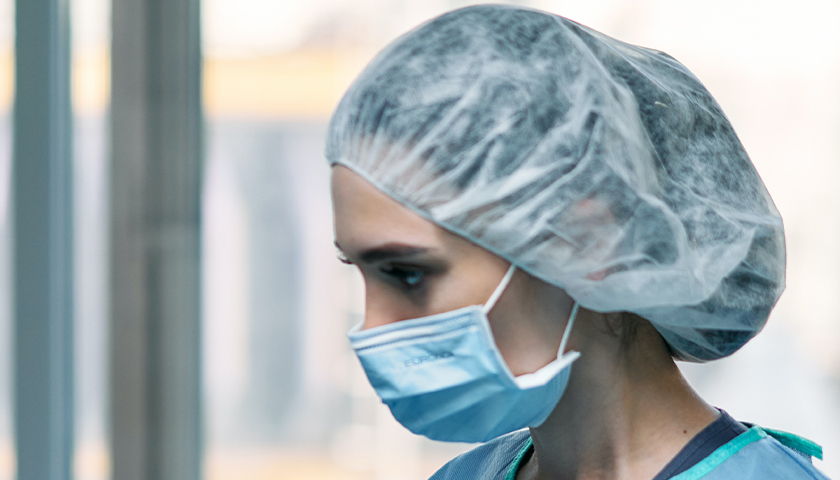 Healthcare worker in hair net and mask