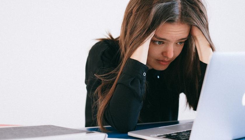 Stressed woman looking at computer