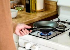 /A person cooking on a gas stove